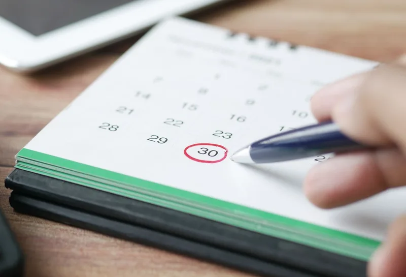 Marking a dryer vent cleaning date on a calendar to schedule maintenance in Gilbert, AZ